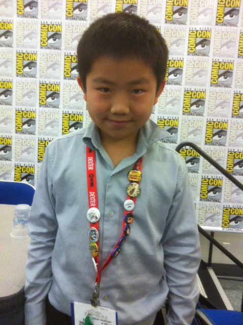 Perry Chen in front of a wall of Comic-Con logos