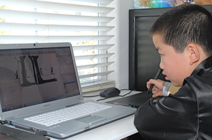 Perry Chen using a laptop and computer tablet to create animation