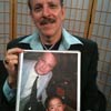Jud Newborn holding a photo of Bill Plympton and Perry Chen